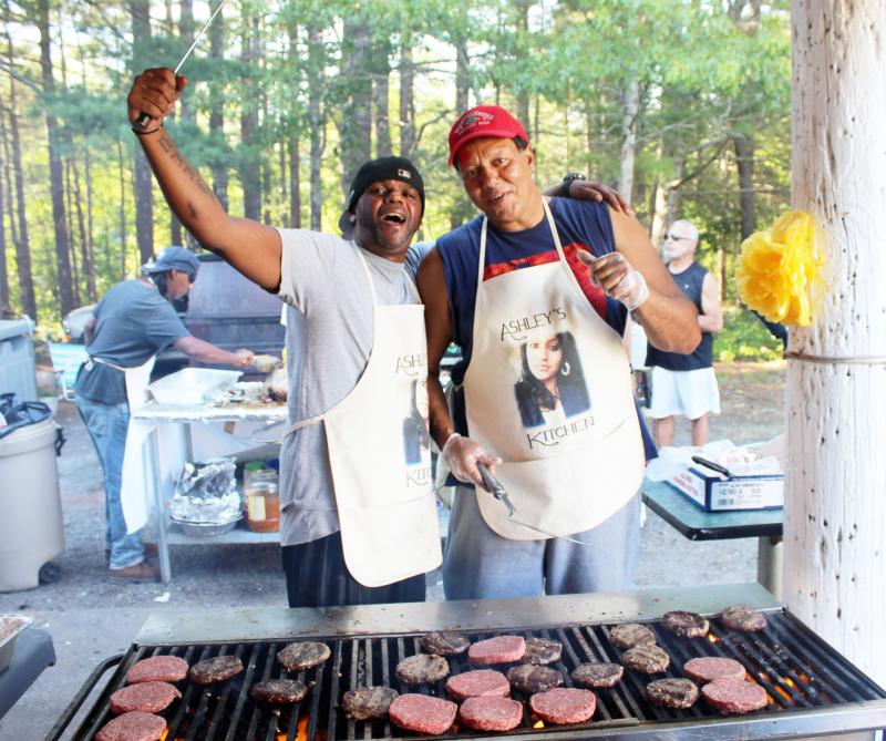 Alando Santos, left, and Mark Andrews man the burger station in "Ashley's Kitchen" at the first-ever Ashley Faye Family Day held in Onset Saturday. BY MATTHEW BERNAT